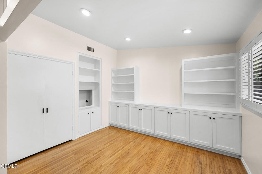 17149 Bullock Street Encino, CA 91316 - Photo 10 of 32 a view of an empty room with a window and wooden floor