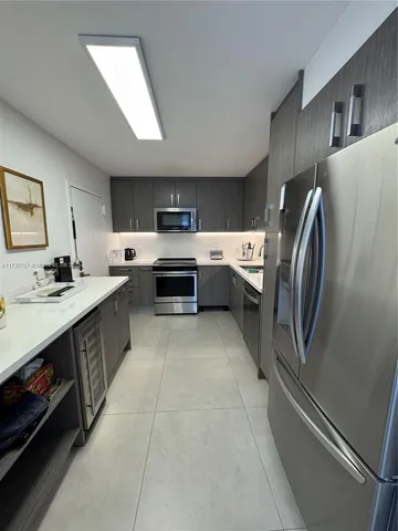 a large kitchen with a stove a sink dishwasher and a refrigerator