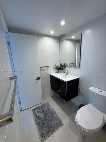 a bathroom with a toilet and a mirror