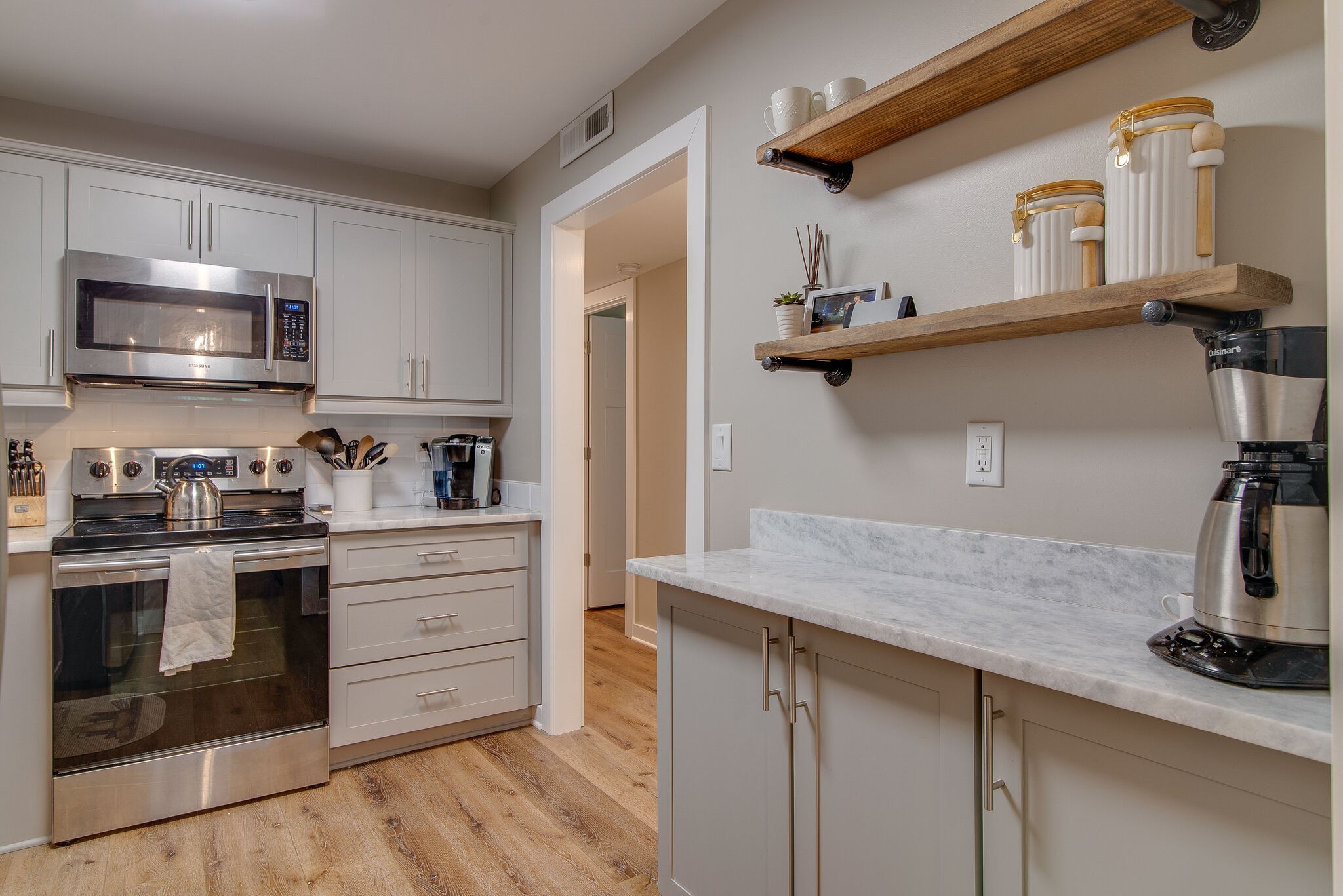 1900 Richard Jones Road, Unit R4 Nashville, TN 37215 - Photo 13 of 32 a kitchen with kitchen island a sink appliances and cabinets