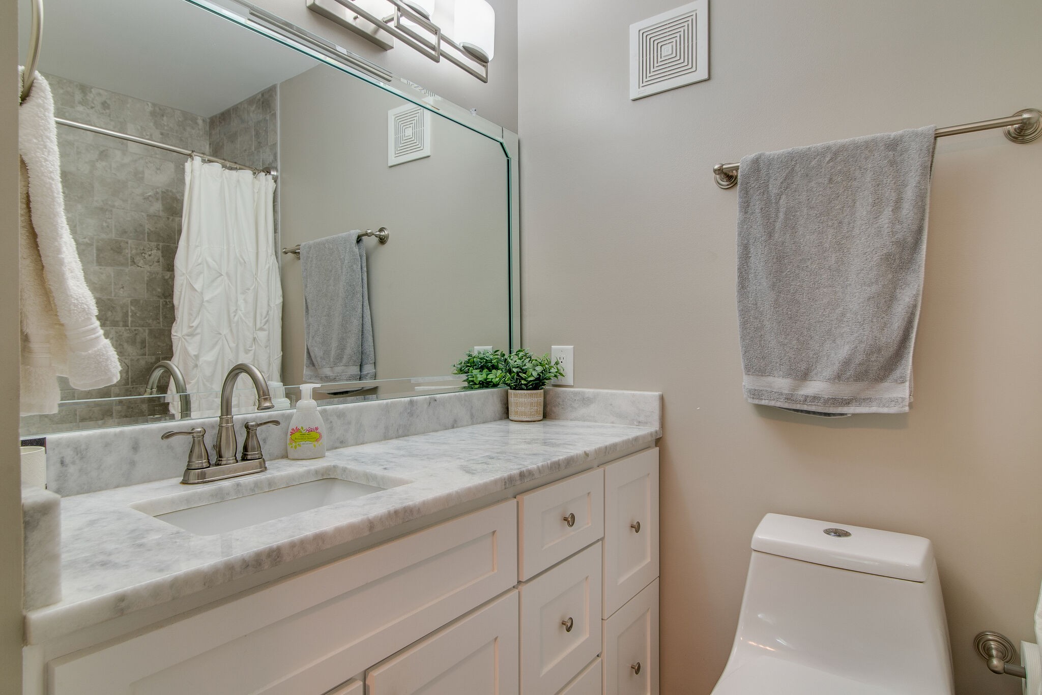 1900 Richard Jones Road, Unit R4 Nashville, TN 37215 - Photo 25 of 32 a bathroom with a granite countertop sink a toilet and a mirror