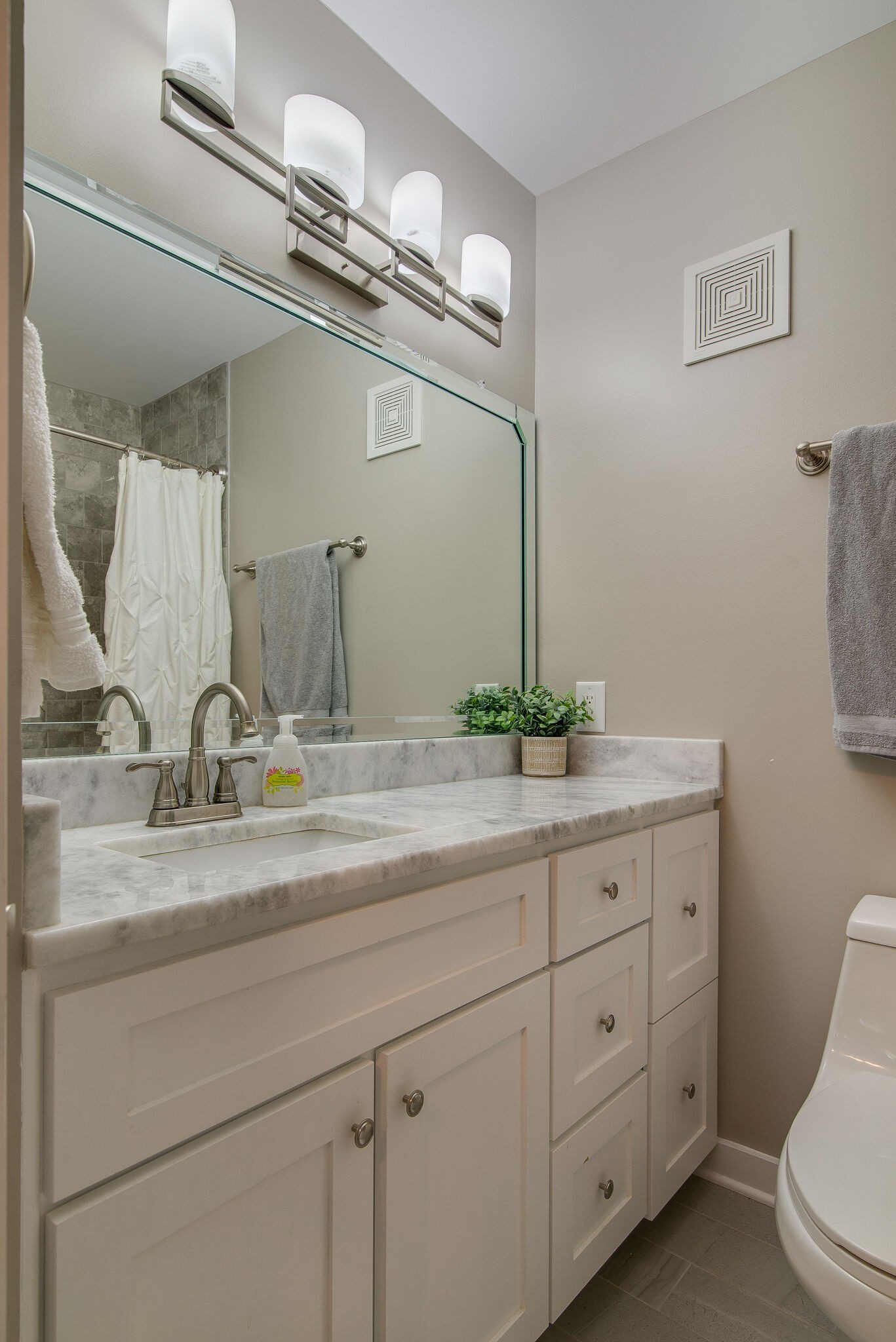 1900 Richard Jones Road, Unit R4 Nashville, TN 37215 - Photo 26 of 32 a bathroom with a granite countertop sink a mirror and a toilet
