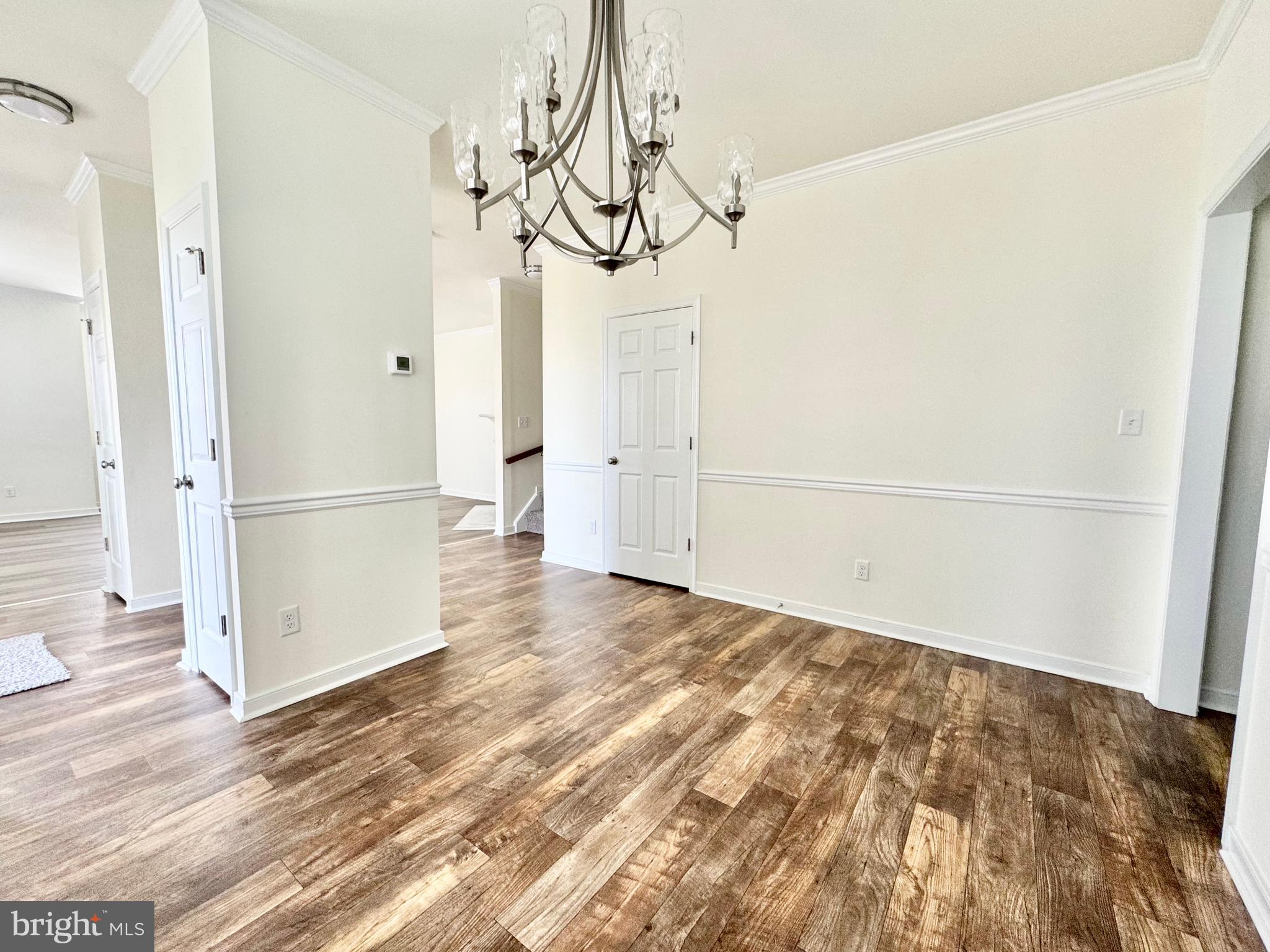 656 Venue Drive Dover, DE 19901 - Photo 12 of 29 a view of empty room with wooden floor and windows