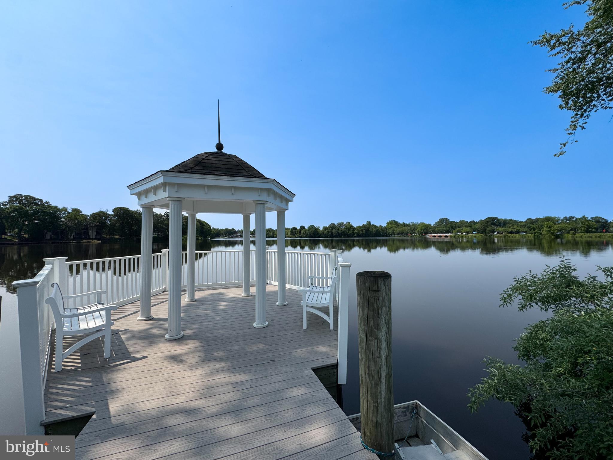656 Venue Drive Dover, DE 19901 - Photo 6 of 29 a roof deck with table and chairs under an umbrella
