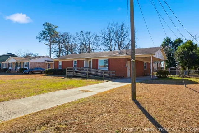 a view of a house with a wooden chairs and a table