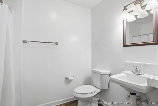 a view of empty room with window and wooden floor