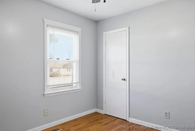 a bathroom with a toilet sink vanity and mirror