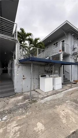 a view of a house with a wooden roof deck