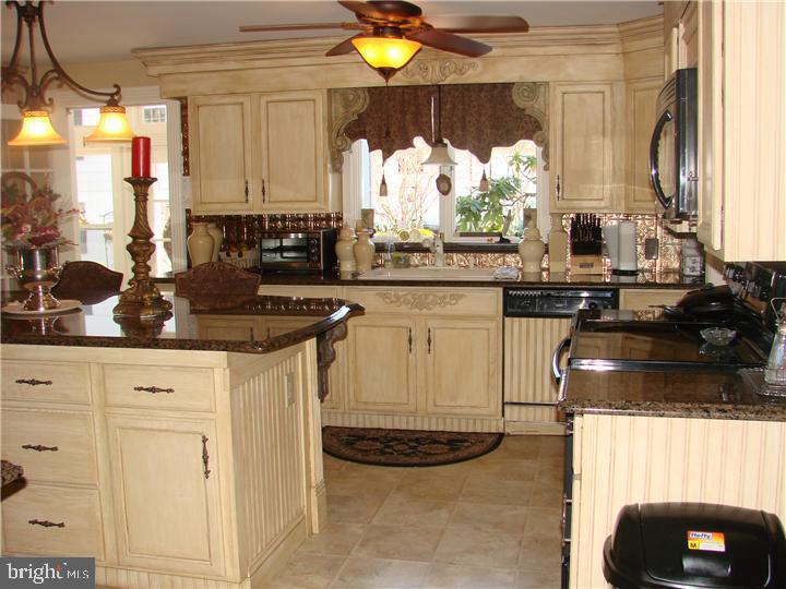 77 Petty Road Cranbury, NJ 08512 - Photo 13 of 32 a kitchen with a stove a sink and a microwave