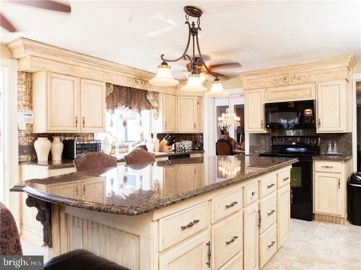 77 Petty Road Cranbury, NJ 08512 - Photo 14 of 32 a kitchen with stainless steel appliances granite countertop a sink a stove counter space and cabinets