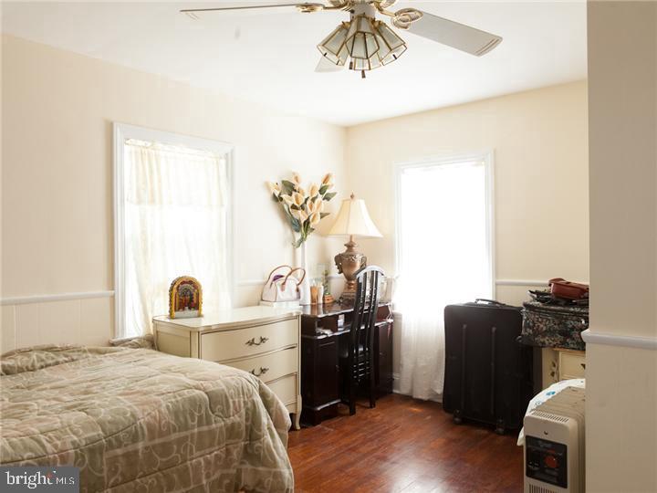 77 Petty Road Cranbury, NJ 08512 - Photo 21 of 32 a bedroom with a bed and a chandelier