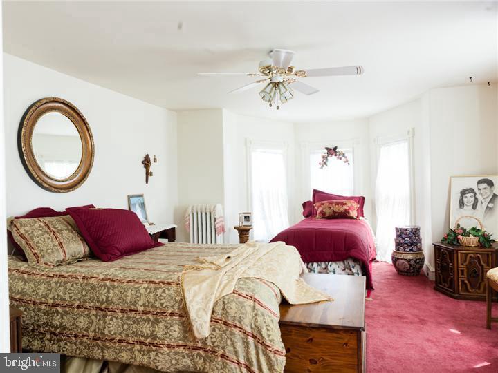 77 Petty Road Cranbury, NJ 08512 - Photo 24 of 32 a bedroom with a bed and a chandelier