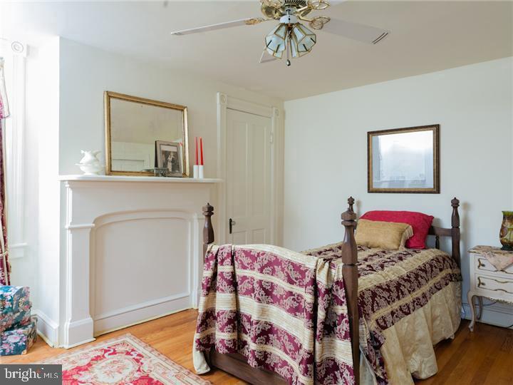 77 Petty Road Cranbury, NJ 08512 - Photo 25 of 32 a bedroom with a bed and a chandelier