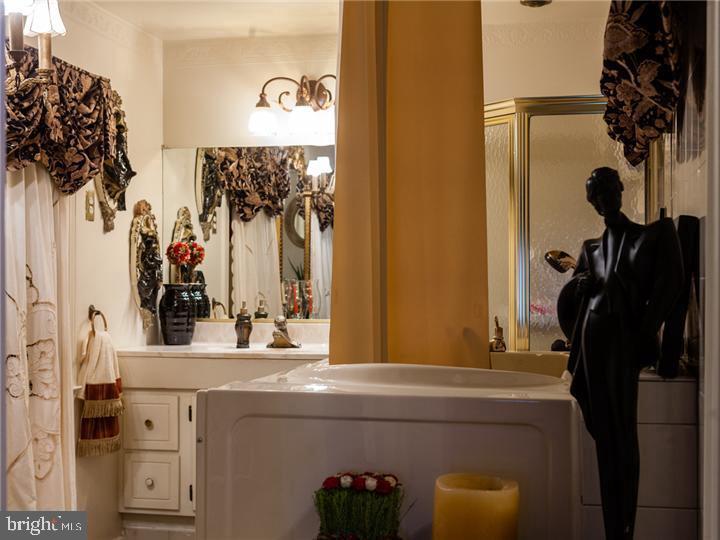 77 Petty Road Cranbury, NJ 08512 - Photo 26 of 32 a bathroom with a granite countertop sink a mirror and shower curtain