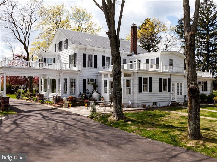 77 Petty Road Cranbury, NJ 08512 - Photo 6 of 32 a front view of a building with street yard and trees