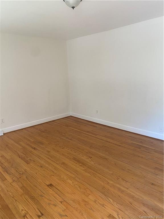 7323 Idlewild Road Charlotte, NC 28212 - Photo 5 of 13 a view of an empty room with wooden floor