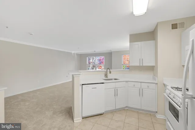 a view of entryway with white walls and refrigerator