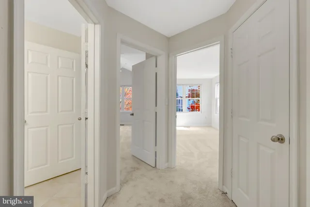 an empty room with a window and ceiling fan