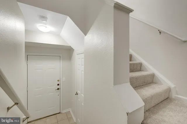 a view of kitchen with refrigerator and window