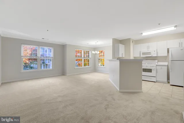 a living room with furniture and a dining table with bookshelf