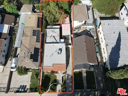an aerial view of residential houses with outdoor space