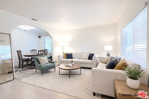 a living room with furniture and a potted plant