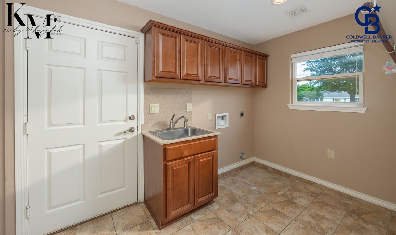 1980 Chappell Ridge Lane Brenham, TX 77833 - Photo 5 of 13 Functional utility room offering convenient space for laundry, storage, and everyday organization, designed to keep household tasks efficient and out of sight