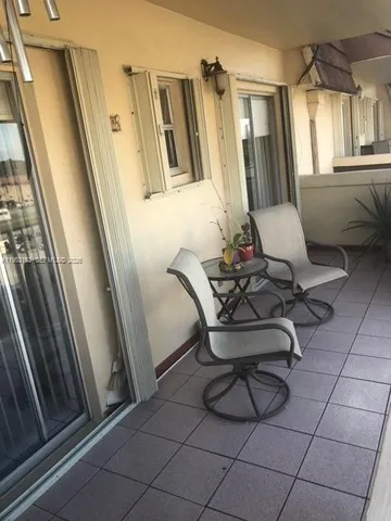 a view of a door and chair in wooden floor