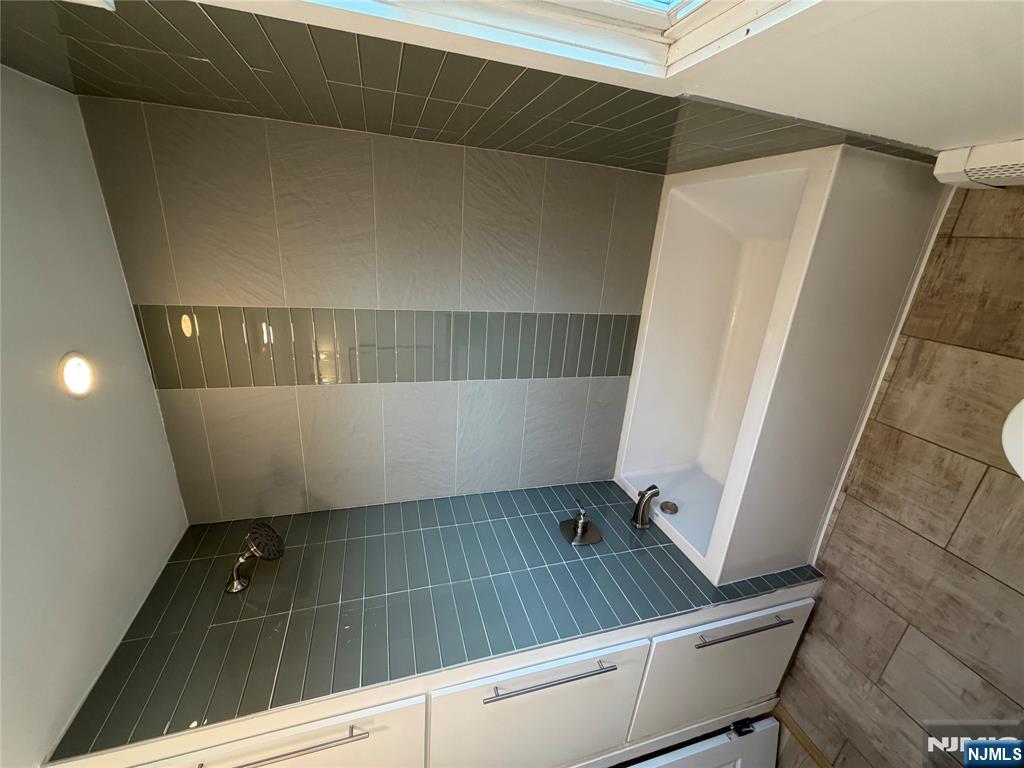 157 Cottage Place, Unit 2 Fairview, NJ 07022 - Photo 11 of 33 a bathroom with a bathtub and a shower