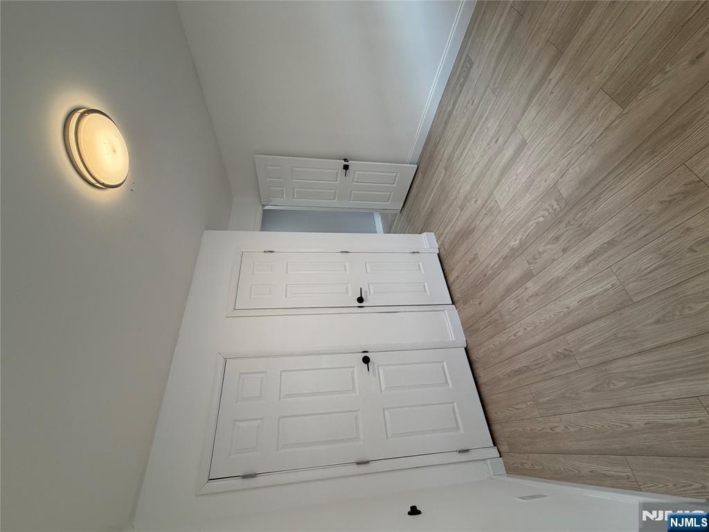 157 Cottage Place, Unit 2 Fairview, NJ 07022 - Photo 16 of 33 a view of a room with wooden floor