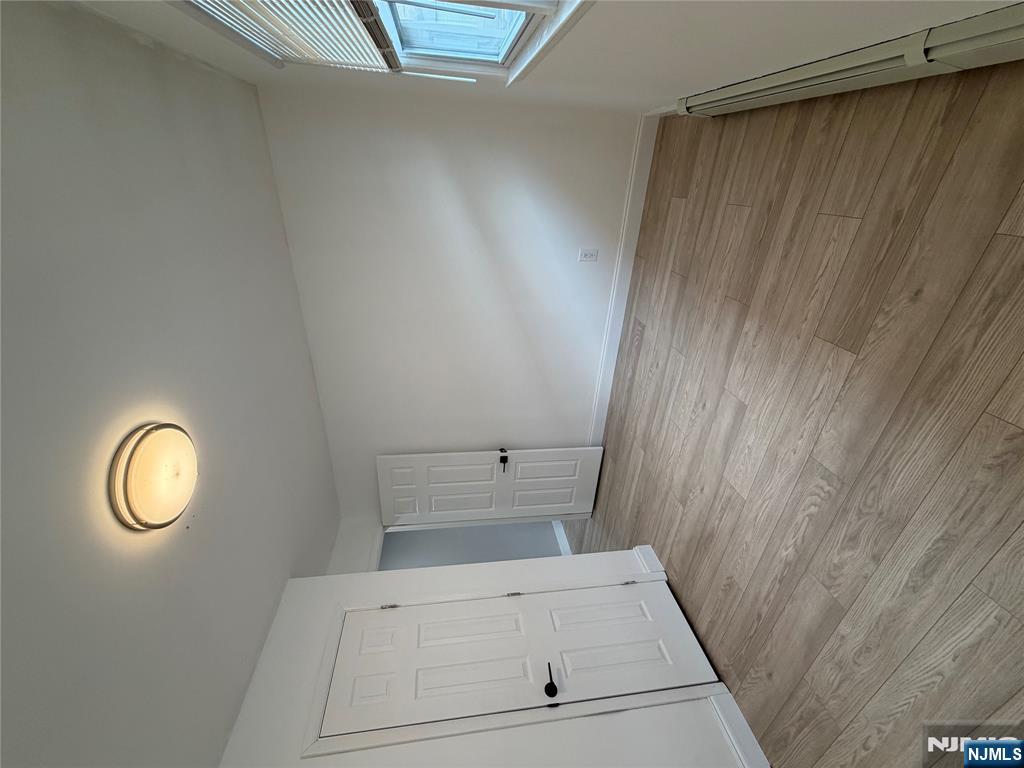 157 Cottage Place, Unit 2 Fairview, NJ 07022 - Photo 17 of 33 a view of empty room with wooden floor and window