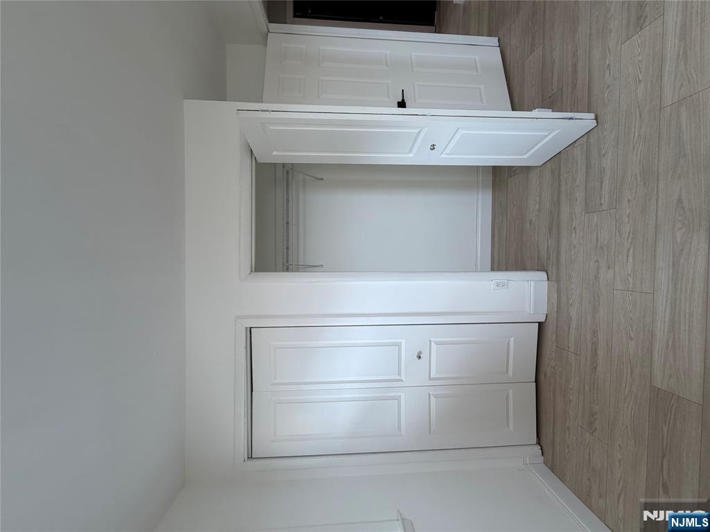 157 Cottage Place, Unit 2 Fairview, NJ 07022 - Photo 19 of 33 an empty room with wooden floor & closet area