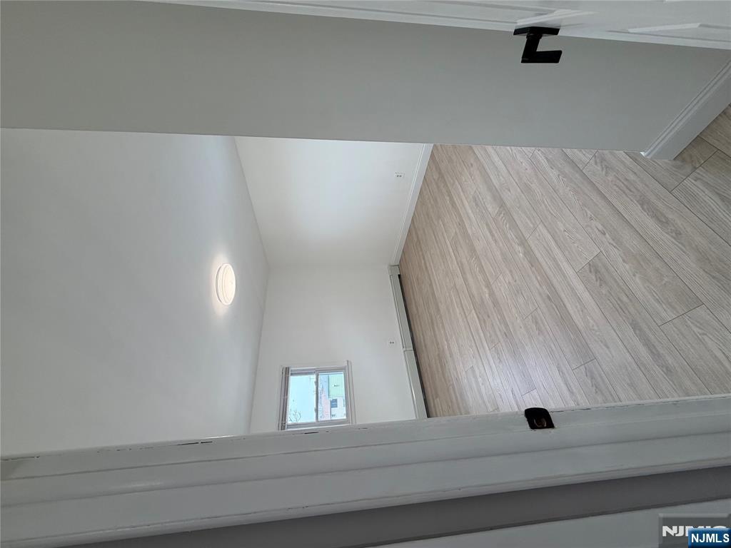 157 Cottage Place, Unit 2 Fairview, NJ 07022 - Photo 20 of 33 a view of an empty room with wooden floor and a window