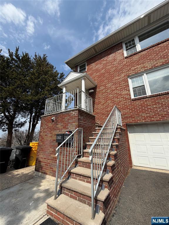157 Cottage Place, Unit 2 Fairview, NJ 07022 - Photo 2 of 33 a view of a house with wooden stairs and a small yard