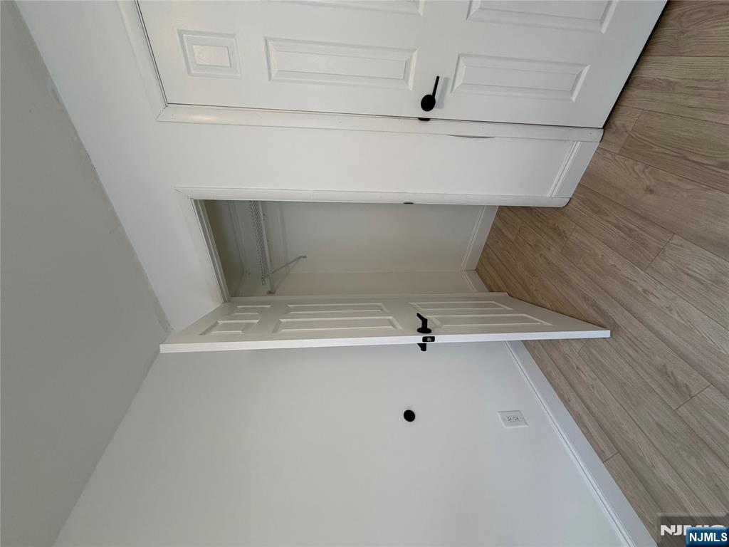 157 Cottage Place, Unit 2 Fairview, NJ 07022 - Photo 21 of 33 a view of an empty room with wooden floor
