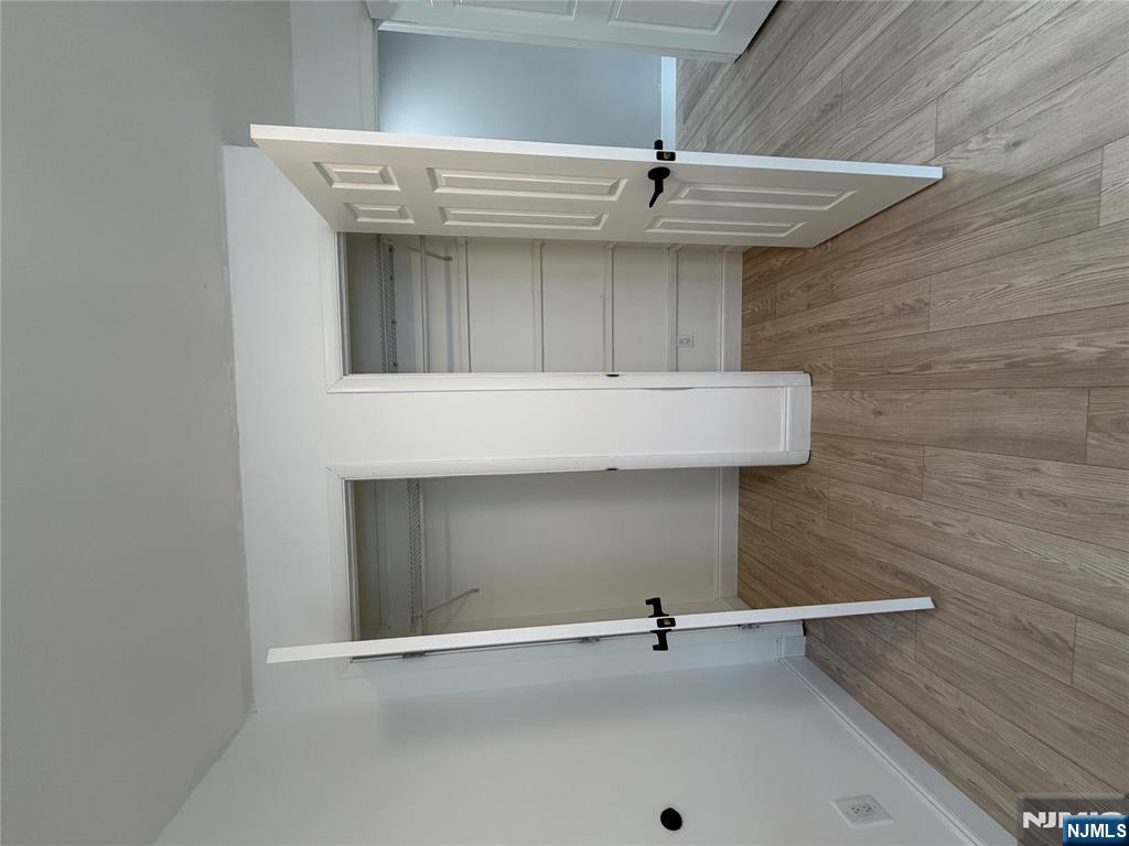 157 Cottage Place, Unit 2 Fairview, NJ 07022 - Photo 22 of 33 an empty room with wooden floor and closet
