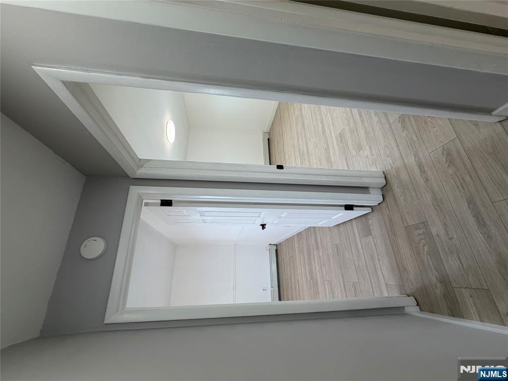 157 Cottage Place, Unit 2 Fairview, NJ 07022 - Photo 23 of 33 a view of a hallway with wooden floor