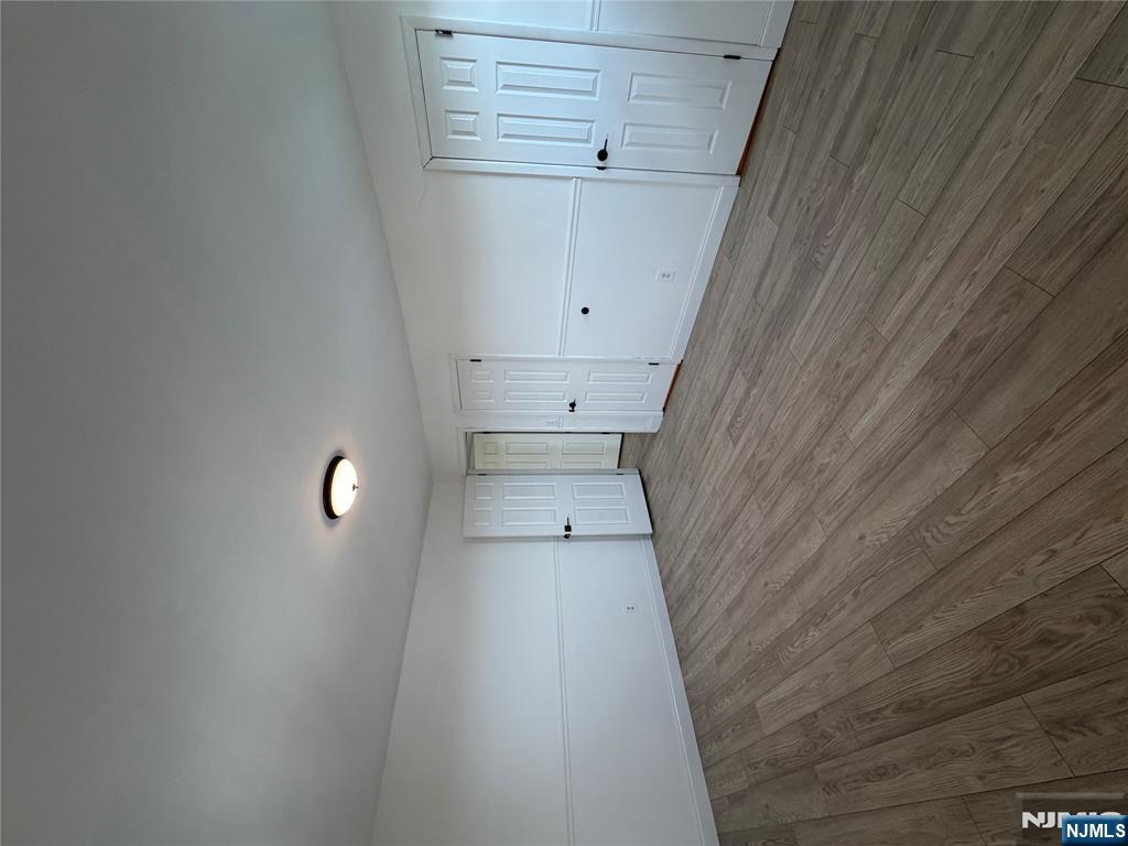 157 Cottage Place, Unit 2 Fairview, NJ 07022 - Photo 25 of 33 a view of an empty room and wooden floor