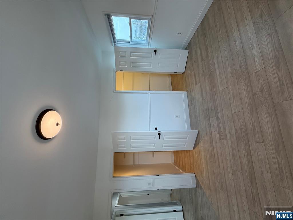 157 Cottage Place, Unit 2 Fairview, NJ 07022 - Photo 26 of 33 a view of empty room with wooden floor