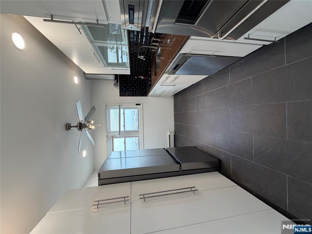 157 Cottage Place, Unit 2 Fairview, NJ 07022 - Photo 3 of 33 a large white kitchen with a stove a refrigerator and a stove top oven