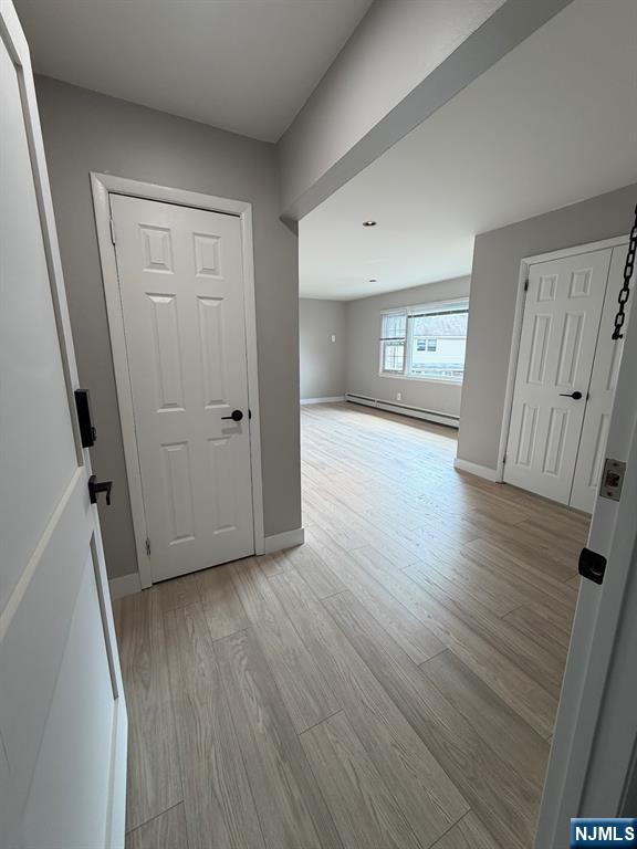 157 Cottage Place, Unit 2 Fairview, NJ 07022 - Photo 31 of 33 an empty room with wooden floor and a window