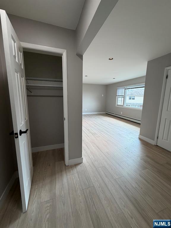 157 Cottage Place, Unit 2 Fairview, NJ 07022 - Photo 32 of 33 an empty room with wooden floor and entrance