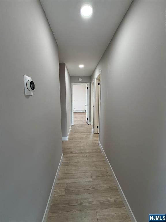157 Cottage Place, Unit 2 Fairview, NJ 07022 - Photo 7 of 33 a view of a hallway with wooden floor
