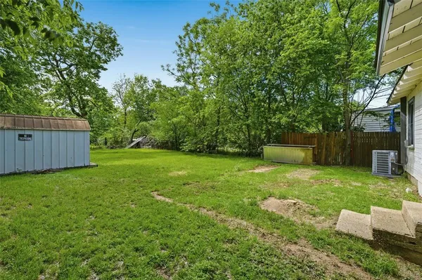 a view of a backyard with a garden and trees
