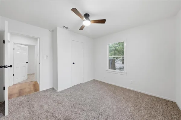 a view of a livingroom with a ceiling fan and window