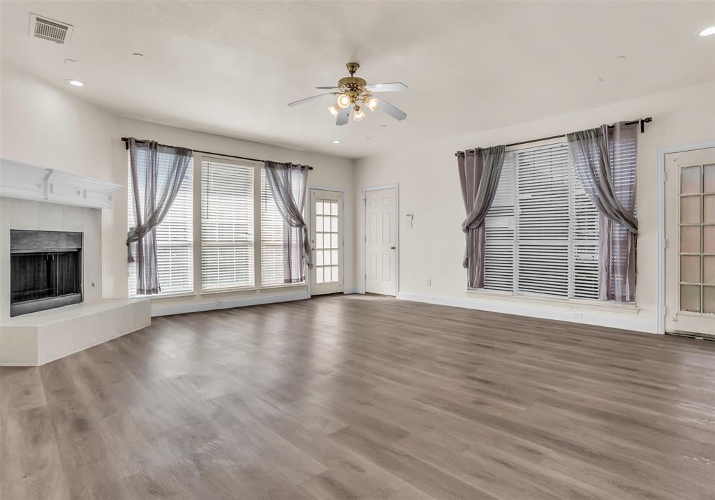 426 Richmond Street Irving, TX 75063 - Photo 11 of 33 a view of an empty room with wooden floor fireplace and a window