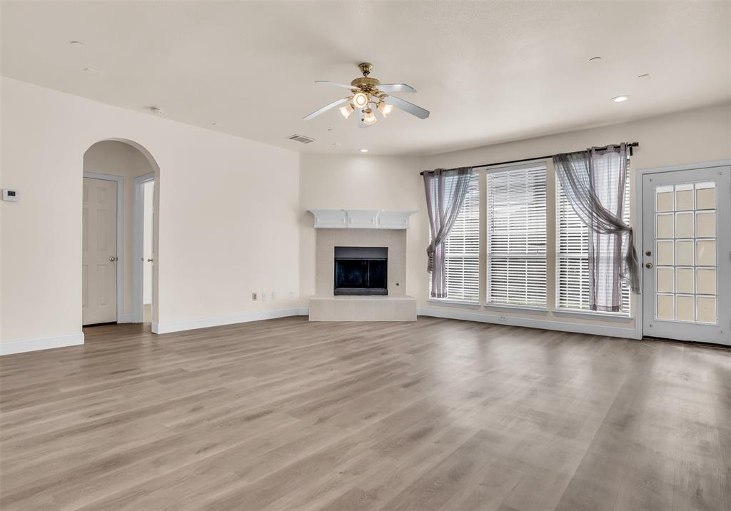 426 Richmond Street Irving, TX 75063 - Photo 12 of 33 an empty room with wooden floor chandelier and windows