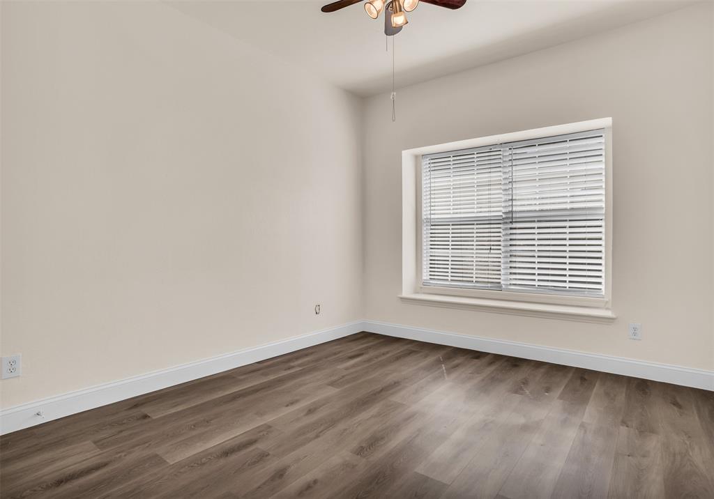 426 Richmond Street Irving, TX 75063 - Photo 13 of 33 a view of an empty room with wooden floor and a window