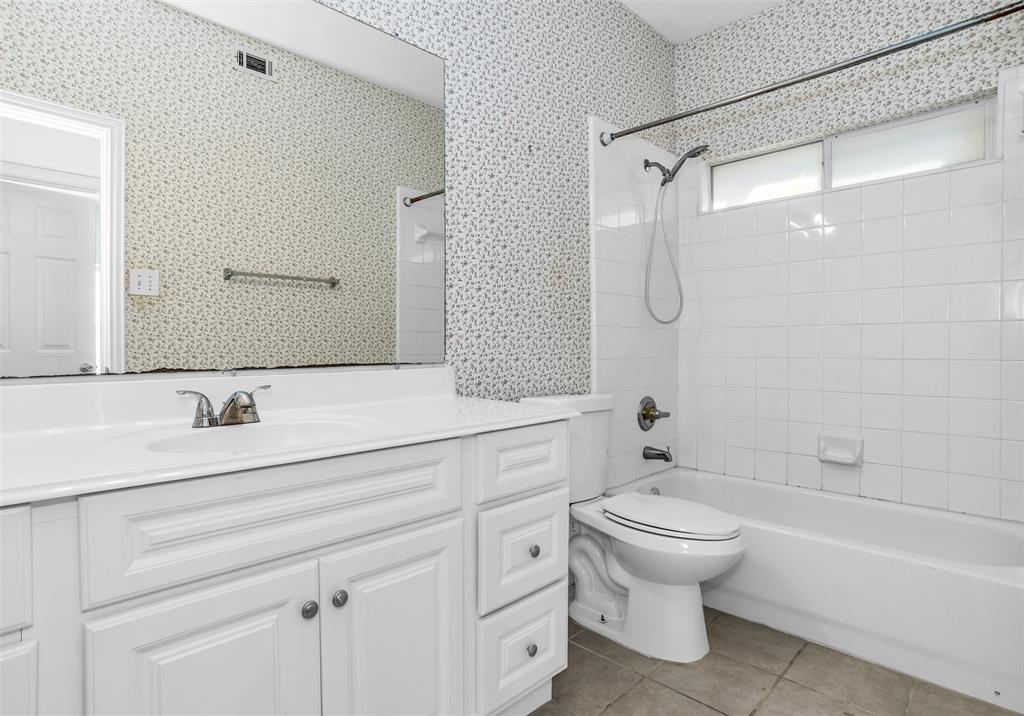 426 Richmond Street Irving, TX 75063 - Photo 14 of 33 a bathroom with a double vanity sink toilet mirror and shower