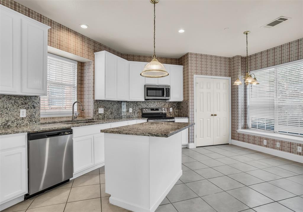 426 Richmond Street Irving, TX 75063 - Photo 17 of 33 a kitchen with granite countertop a sink and a refrigerator